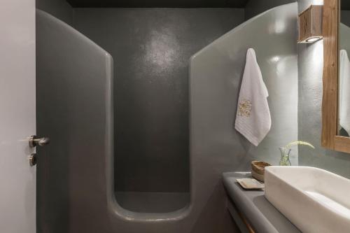 a bathroom with a sink and a toilet and a mirror at Executive Paros Villa Villa Aiolos Private Pool & Jacuzzi Villa Kostos Damouli in Kampos Paros