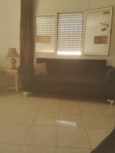 a living room with a couch and a window at Kelibia - Villa La Marsa plage in Kelibia