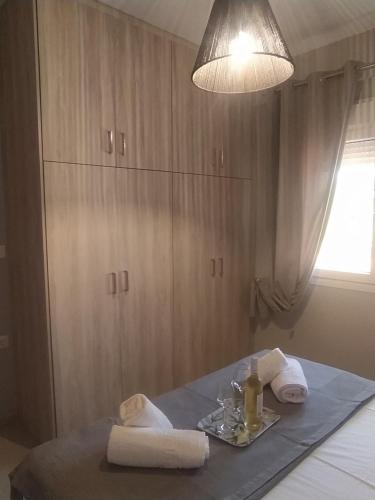 a table with towels and a plate of food on it at Dimis Apartment in Chrysoupolis