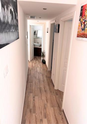 a hallway with wood floors in a room at Gioia in Leuca
