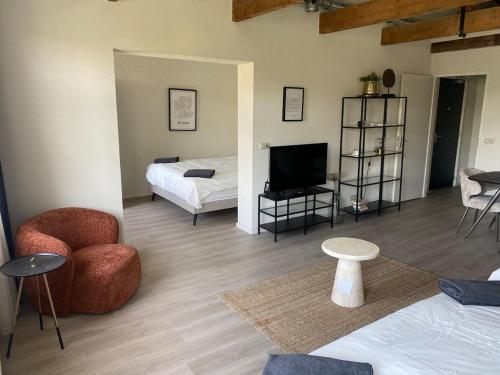 a living room with a bed and a television at Cozy and centrally located - 6 persons apartment in Rotterdam