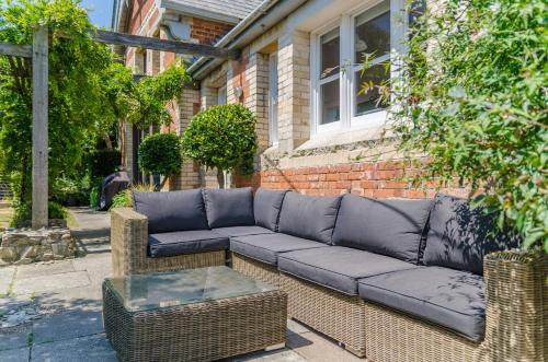 a couch sitting on the side of a house at Luxury Victorian school with views of Harbour in Fowey