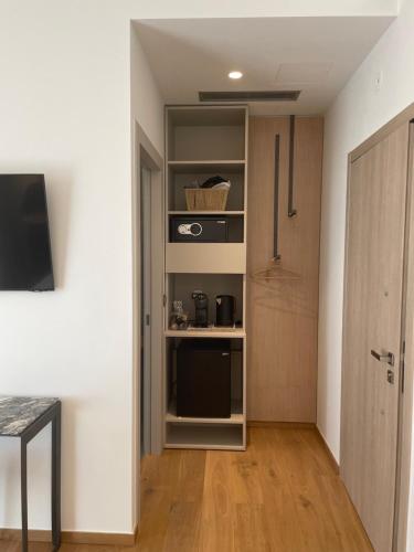 a room with a kitchen with a pantry and a door at Nõs Luxury Rooms in Mesolongion