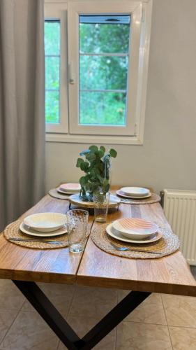a wooden table with plates and glasses on it at Diamond Corfu Viros Suite in Bastoúnion