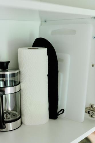 a roll of toilet paper sitting on a counter at Your Lutsu Apartment Lux Retro Prime Spot in Viljandi