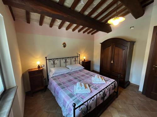 a bedroom with a bed with two slippers on it at Il Casaletto Visso - Appartamenti in Visso