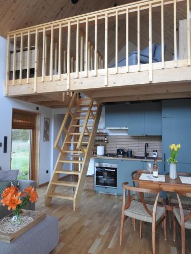 a loft bed in a kitchen and a dining room at Dolina nad Drawa 