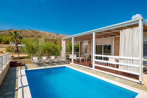 a house with a swimming pool and a patio at Terra Park SpiritoS in Kolan
