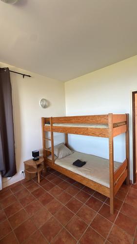 a room with two bunk beds and a flat screen tv at Gîte U Saltu in Solaro