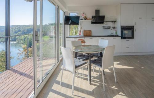 a kitchen with a table and chairs and a balcony at Nice Home In Dobrenici With Sauna in Generalski Stol