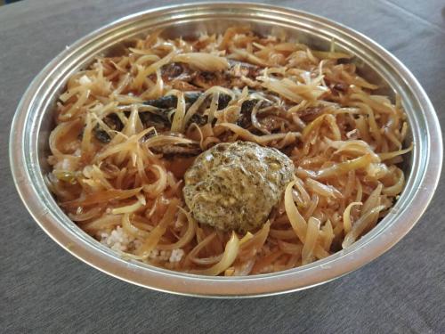 a bowl of pasta with a ball of cheese at Campement Adia Fougnesse chez Pape Badiane 