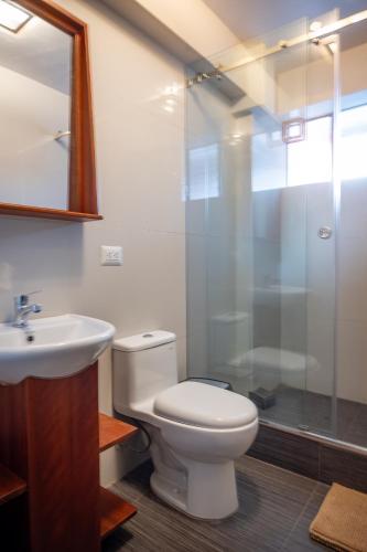a bathroom with a toilet and a sink and a shower at Ayra Hotel Boutique in Pisac