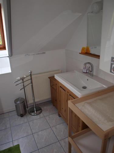 a white kitchen with a sink and a counter at Ferienwohnung Heider in Neusiedl am See