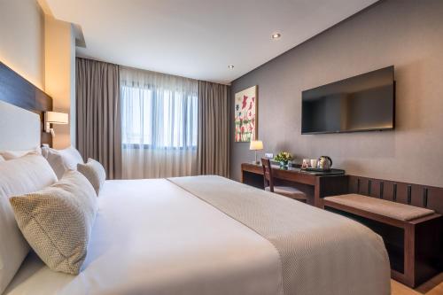 Uma cama ou camas num quarto em Occidental Granada