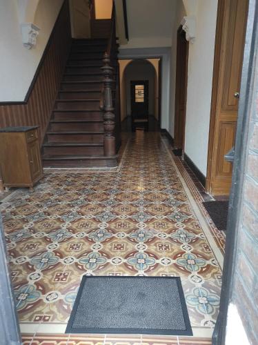 a hallway with a tile floor and stairs at Gutshaus Michelshof in Kevelaer