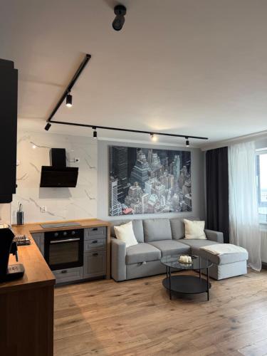 a living room with a couch and a table at Apartament City Rent Płock 3 in Płock