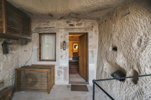 a hallway of a stone building with a door at Vie Cappadocia - Adults Only in Nevsehir