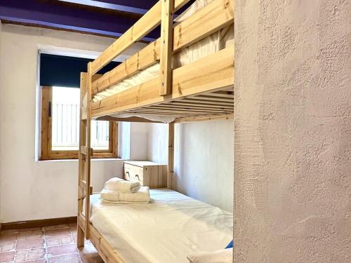 a loft bed in a room with a bunk bed in it at La Caseta de Palamós in Palamós