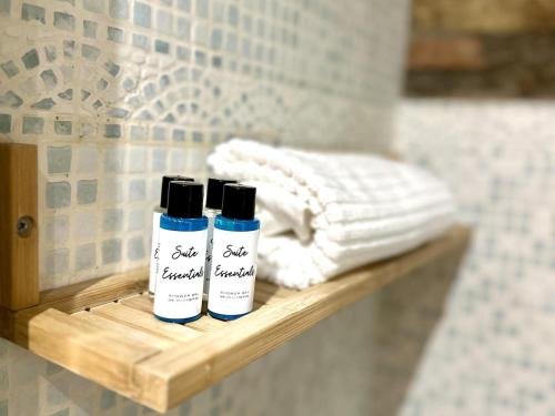 two bottles of soap sitting on a shelf in a bathroom at La Caseta de Palamós in Palamós