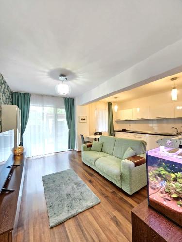 a living room with a couch and a table at The Solstice Garden Suites in Cluj-Napoca