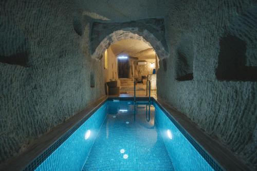 a swimming pool in a building with a tunnel at Vie Cappadocia - Adults Only in Nevsehir