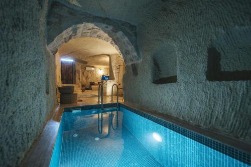 a large swimming pool in a building with a tunnel at Vie Cappadocia - Adults Only in Nevsehir
