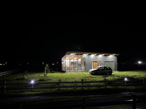 a small house with a car parked in front of it at night at Pelli in Parral