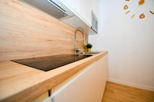 a kitchen with a sink and a wooden counter top at Sandy Shores Oasis in Playa de San Juan