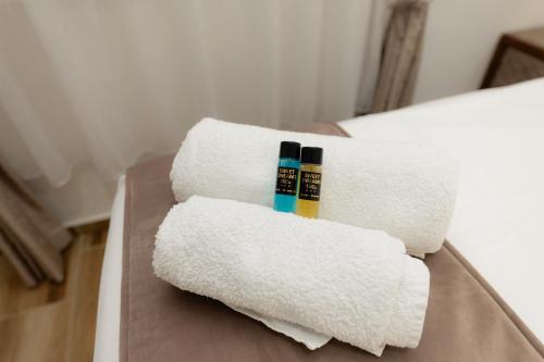 two towels and two toothbrushes sitting on a bed at Villa Sweet Dreams in Novi Sad