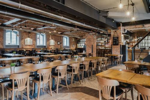 a row of tables and chairs in a restaurant at Craft Beer Central Hotel in Gdańsk