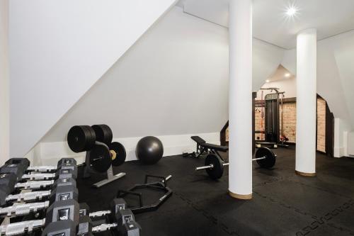 a gym with dumbbells and weights in a room at Craft Beer Central Hotel in Gdańsk