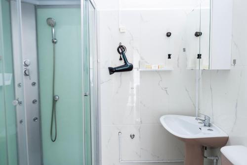 a bathroom with a shower and a sink at Residencial Princesa do Ave in Vila do Conde