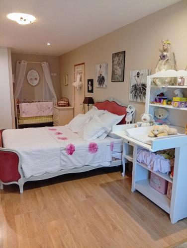 a bedroom with a white bed and a desk at Chambre Romance in Pajay