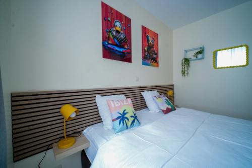 a bedroom with two white beds and a wooden headboard at Slina Hotel Brussels in Brussels