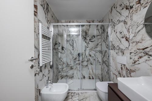 a bathroom with a shower and a toilet and a sink at Park Towers 15 - Design - Large Terrace - AC in Milan
