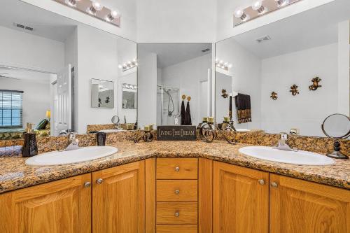 a bathroom with two sinks and a large mirror at Peaceful and Relaxing Community - Peace of Cape - Roelens in Cape Coral