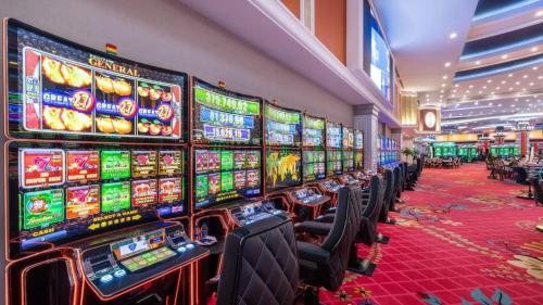 a row of slot machines in a casino at Merit Royal Gardens Hotel & Casino in İskele