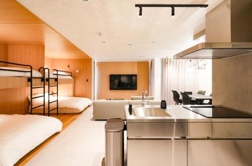a kitchen and living room with a bunk bed at NESTo KAMATA in Tokyo