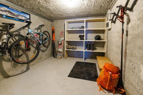 a small room with a bike and some snowboards at Chalet Beppe in Bormio
