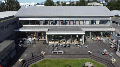 a building with a courtyard with tables and chairs at Dalur - HI Eco Hostel in Reykjavík