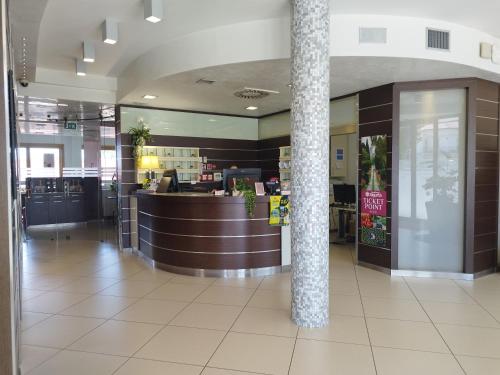 a lobby of a restaurant with a bar in it at Kairos Garda Hotel in Castelnuovo del Garda