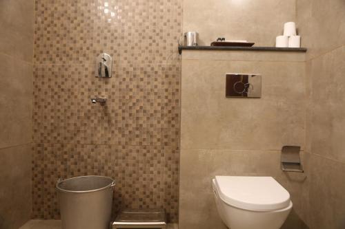 a bathroom with a toilet and a sink in it at Vedic Dham Ganga in Rishīkesh
