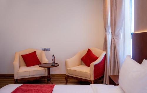 two chairs and a table in a hotel room at The Mavvel Hotel in Kangaru