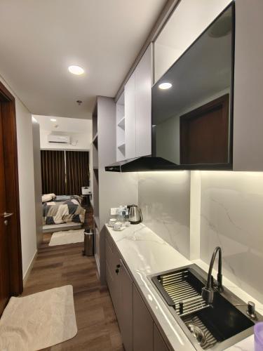 a kitchen with a sink and a counter top at Pollux Habibie Batam Polux in Batam Center