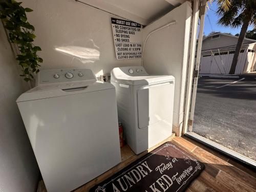 a washer and dryer sitting outside of a garage at Privet Studio 10 Min To Beach - 17 in Clearwater