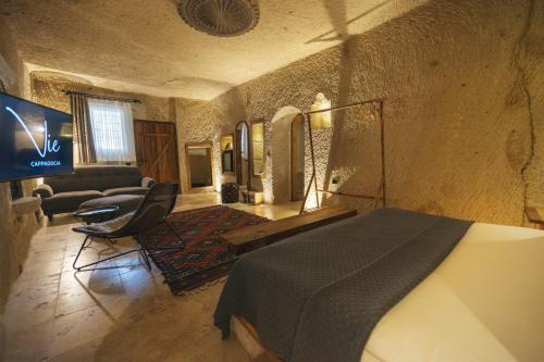 a bedroom with a bed and a living room at Vie Cappadocia - Adults Only in Nevsehir
