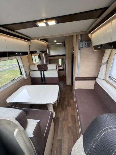 an interior view of an rv with empty seats at Fiat Mc Louis Camper Van RV in Reykjavík