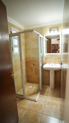 a bathroom with a shower and a sink at Winds Hill Resort & Spa in Merlo