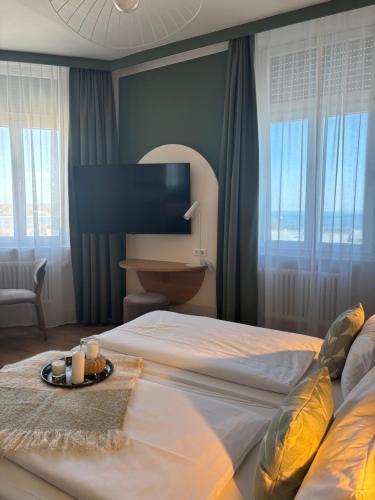 a bedroom with a bed with a tray of candles on it at Gästehaus Centro in Konstanz in Konstanz
