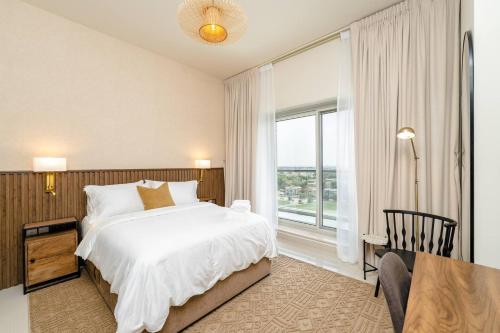 a bedroom with a bed and a large window at Special Rates - Elegant Studio - Golf Views in Dubai